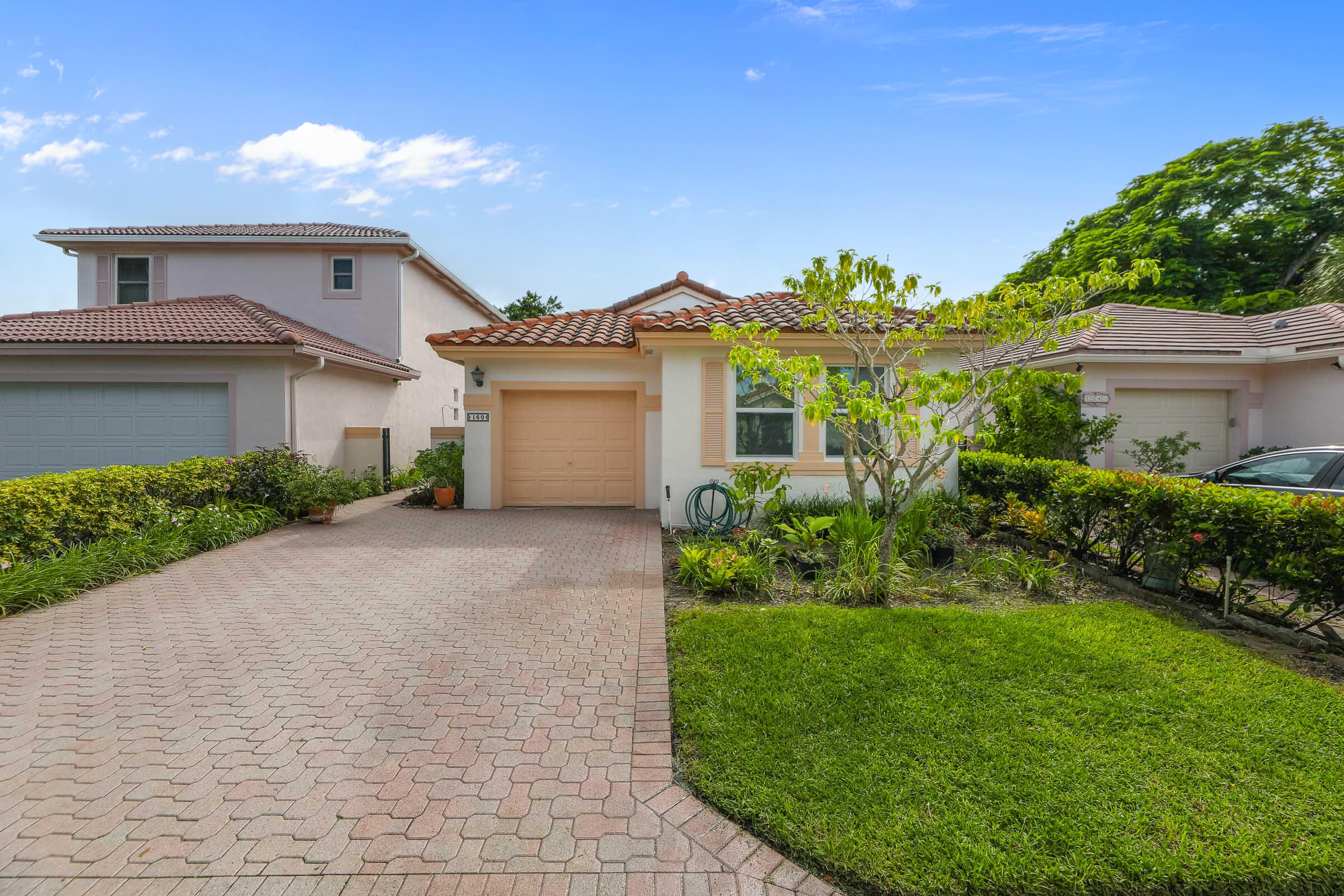 a front view of a house with a garden