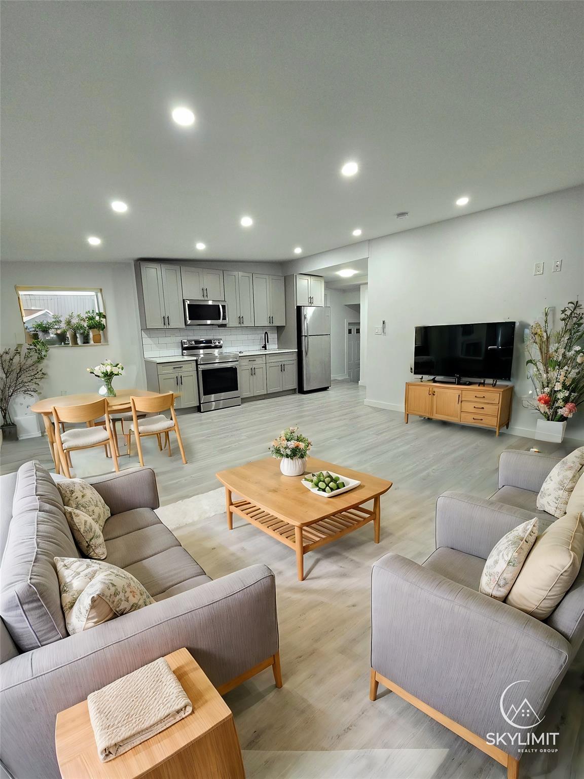 Living room featuring light hardwood / wood-style flooring and sink