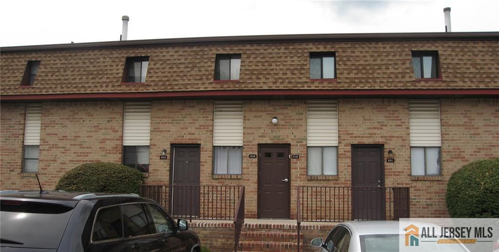 a front view of a house with parking space