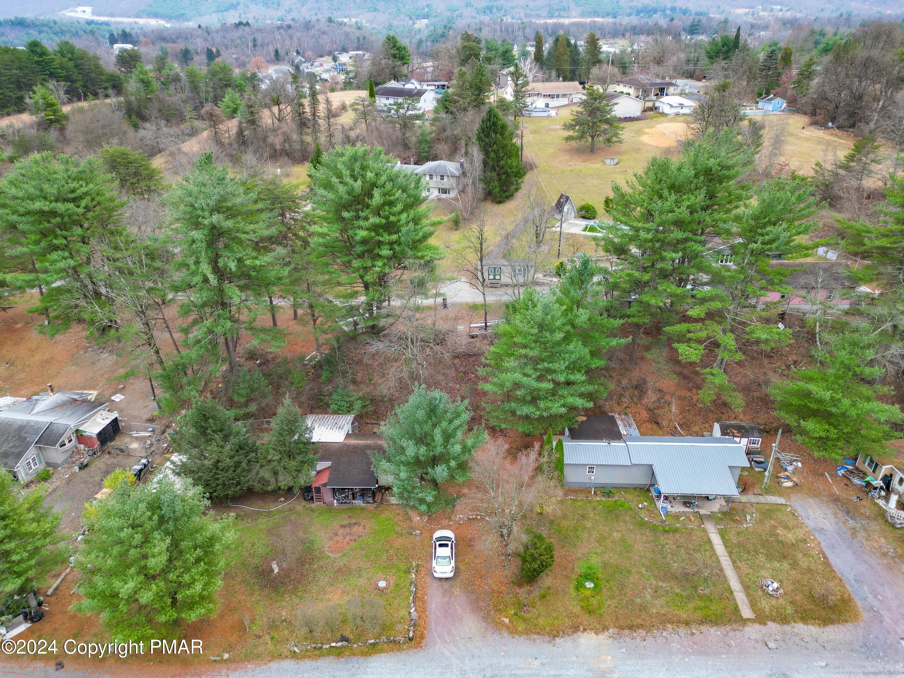 an aerial view of a house with a yard and lake view