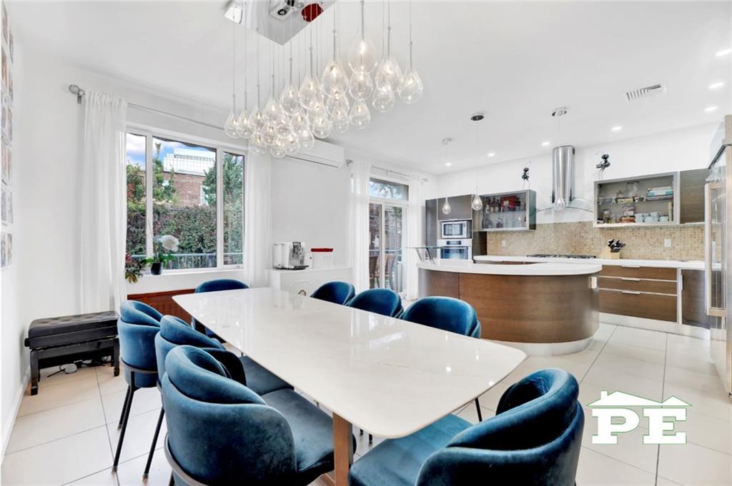 a large kitchen with a table and chairs