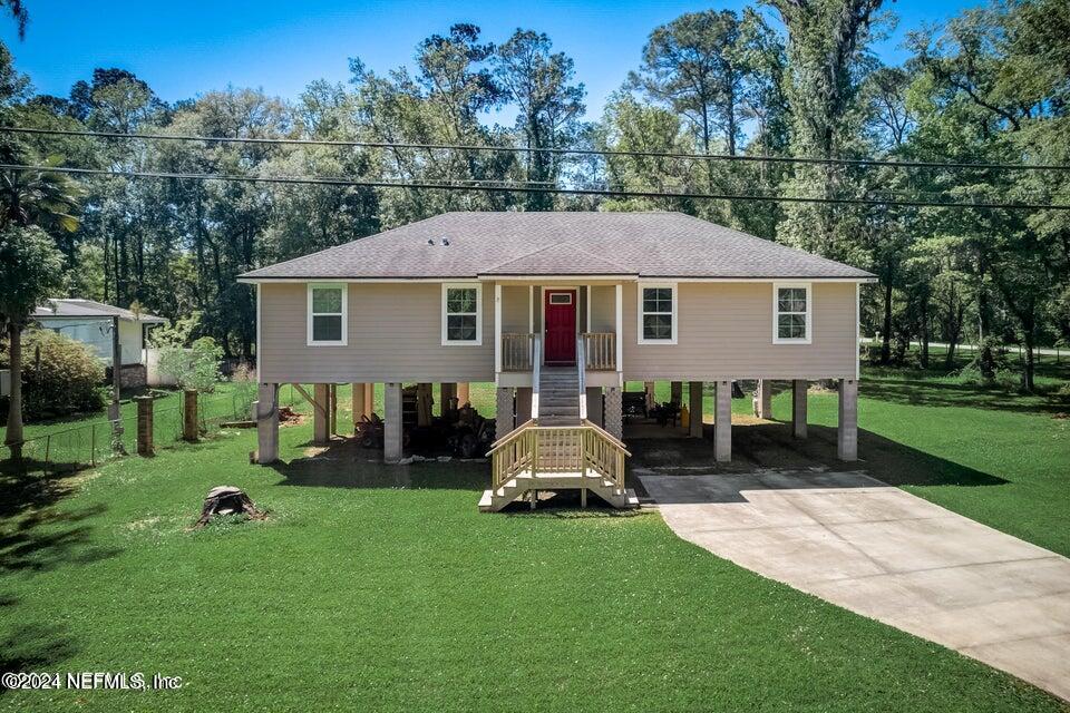 a front view of house with yard and green space