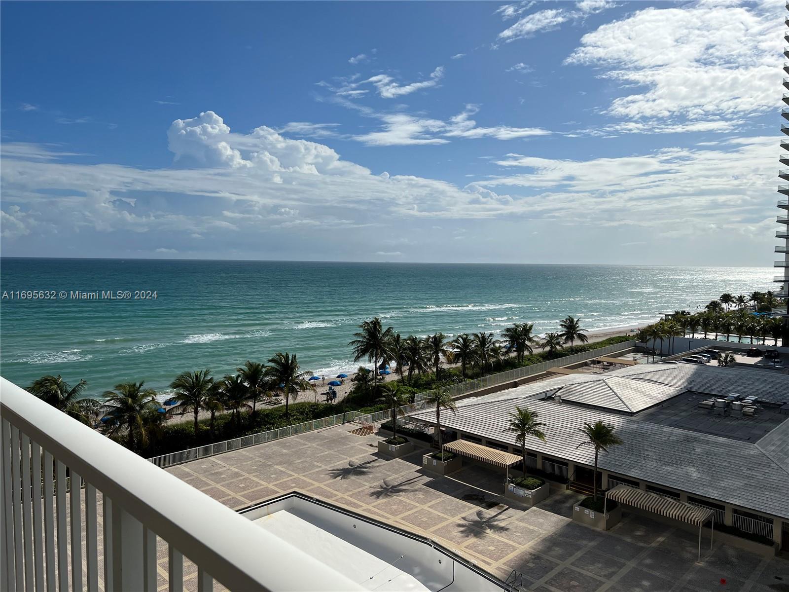 a view of a terrace with wooden floor and ocean view