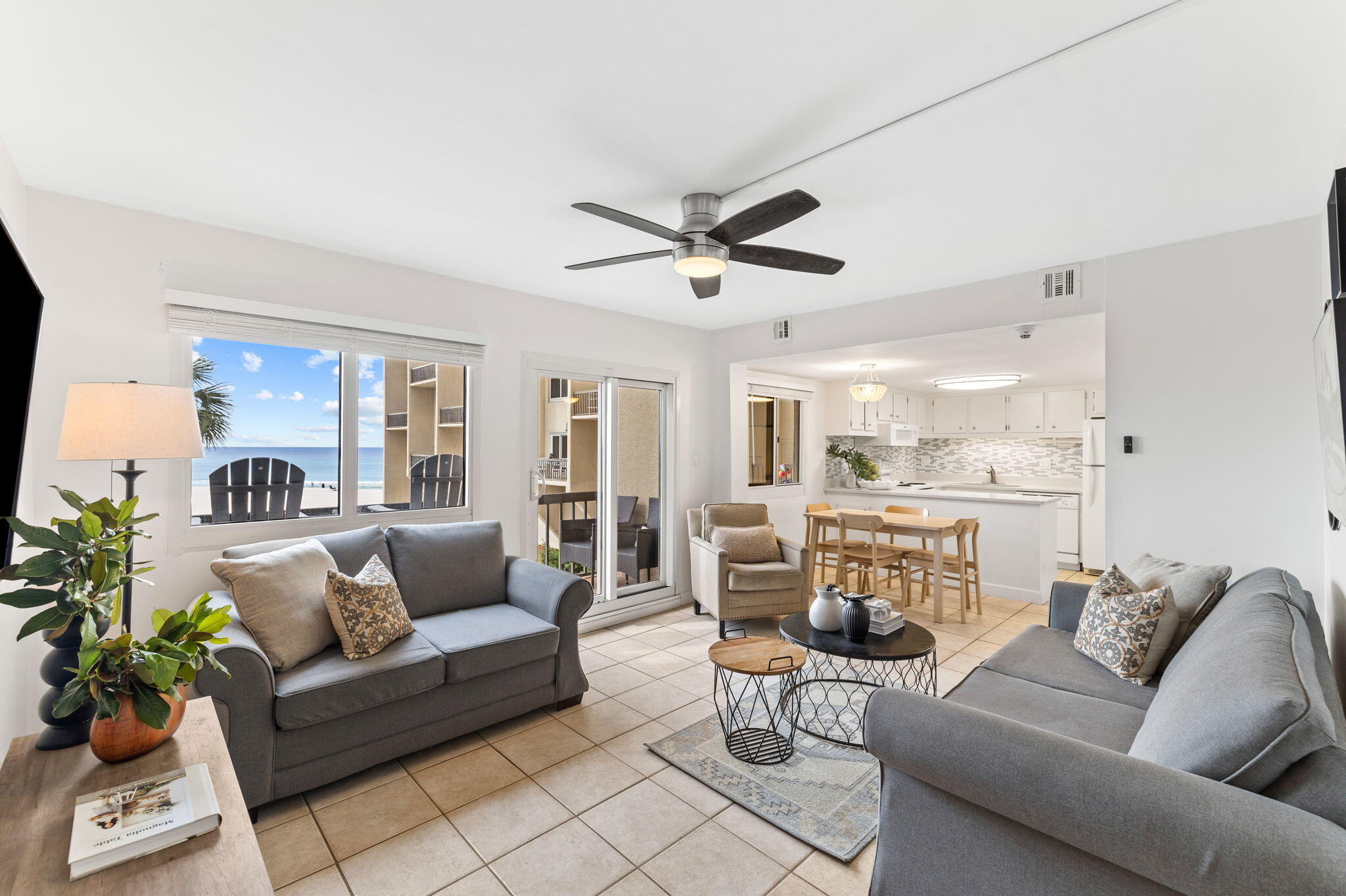 a living room with furniture ceiling fan and a rug