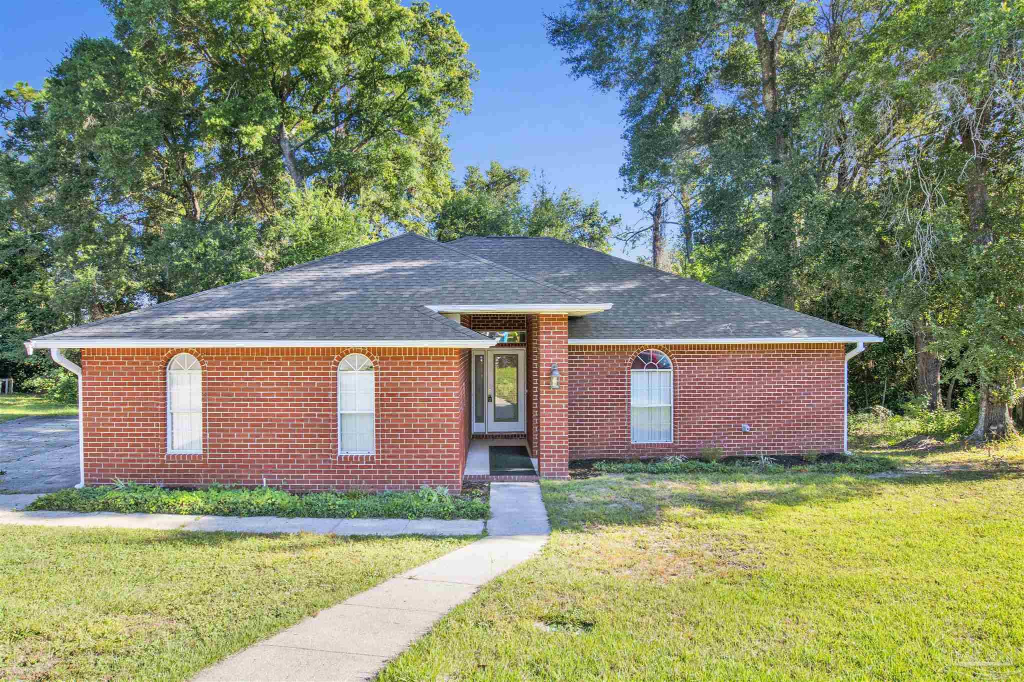 a front view of house with yard and green space