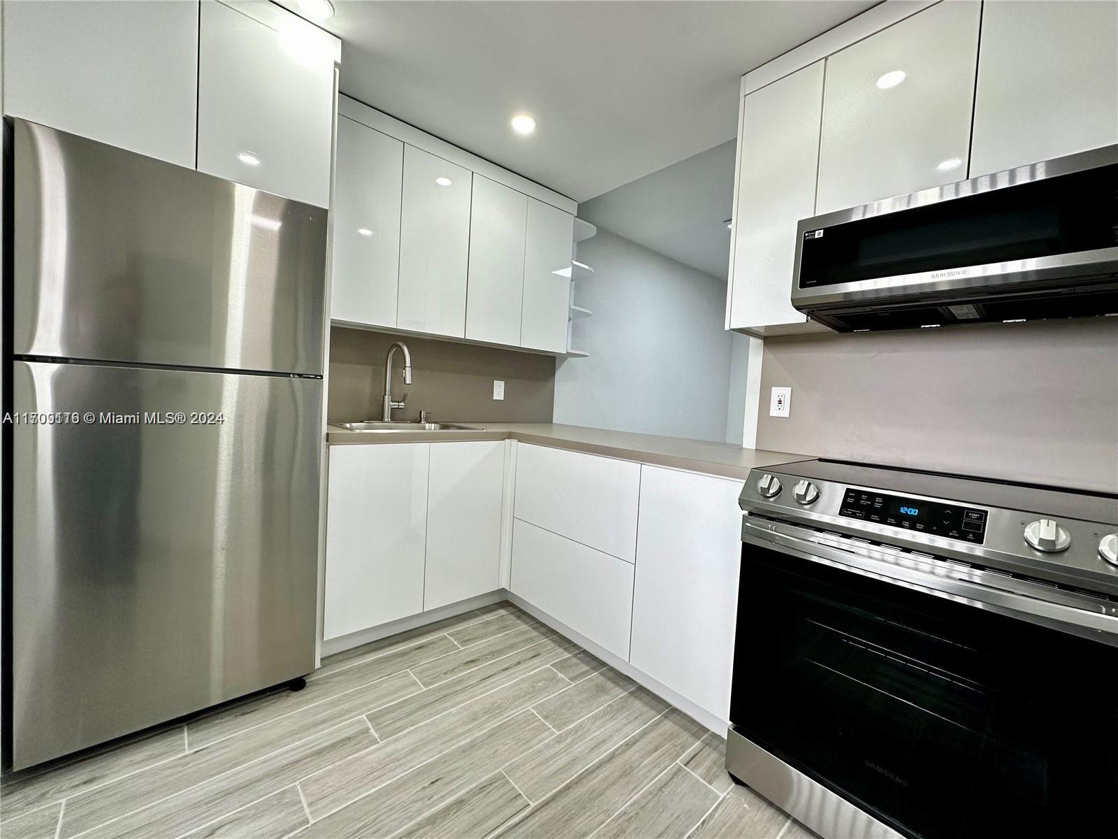 a kitchen with a refrigerator and a stove