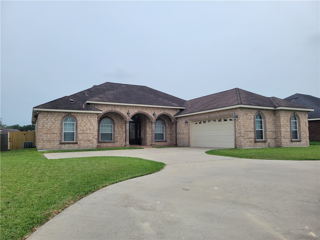 a front view of a house with a yard and garage