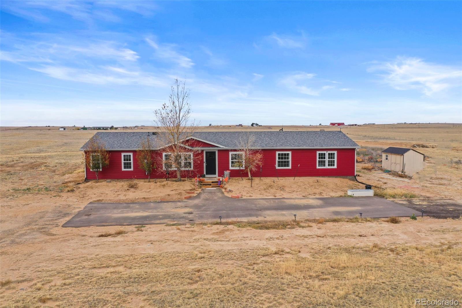 a view of a red house with a yard