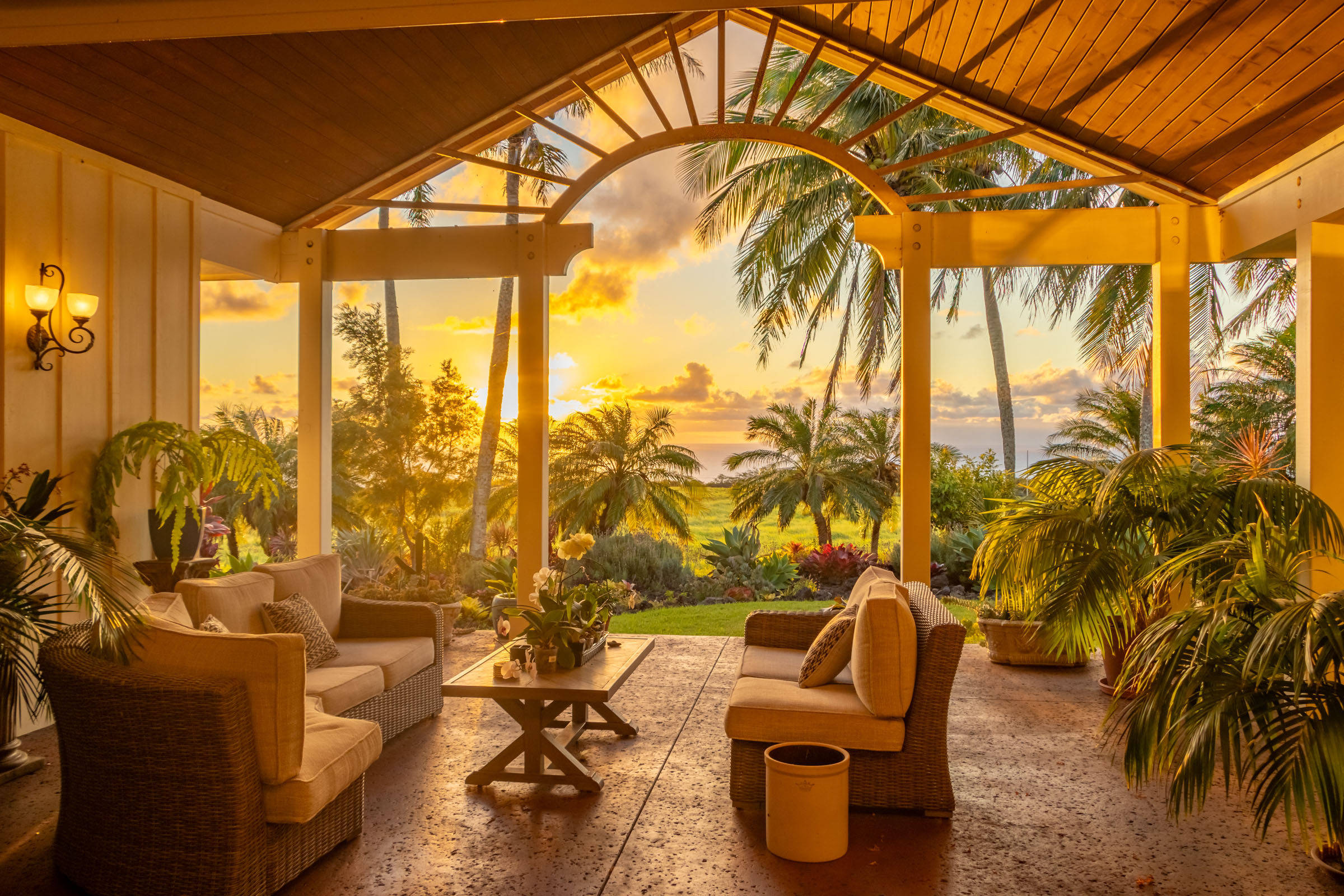 a view of a patio with couches and swimming pool