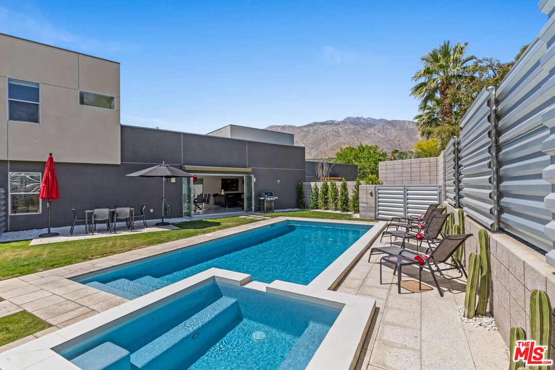 a view of swimming pool with lounge chairs