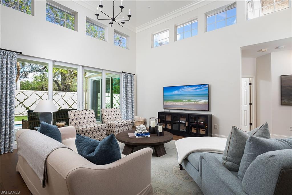 a living room with furniture fireplace and a large window