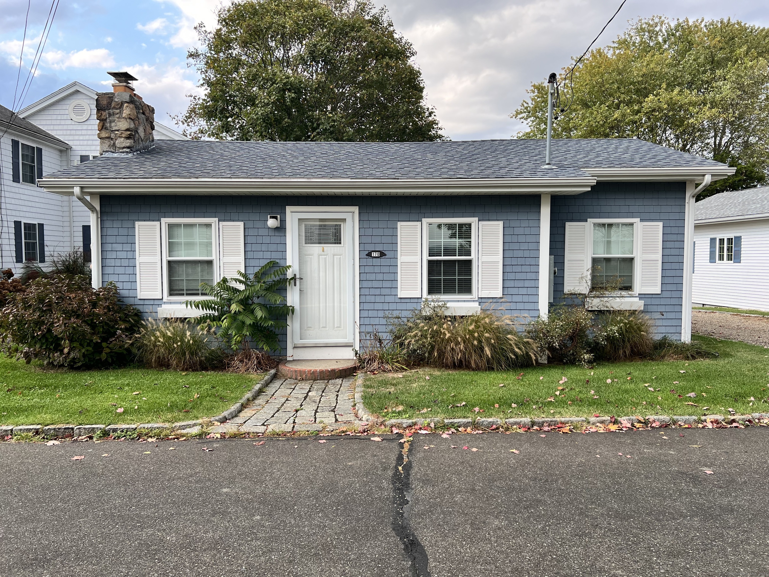 a front view of a house with a garden and yard