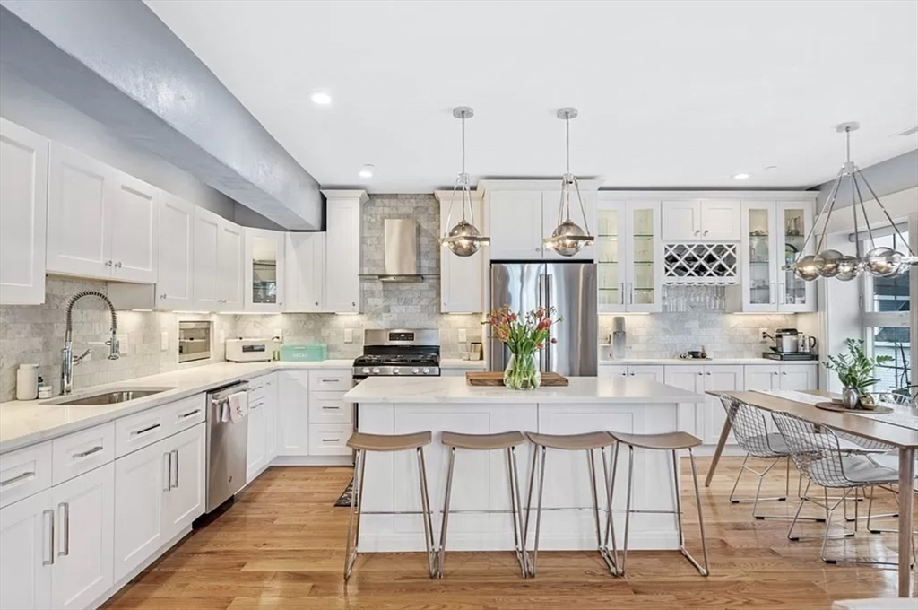 a open kitchen with stainless steel appliances kitchen island granite countertop a sink and cabinets