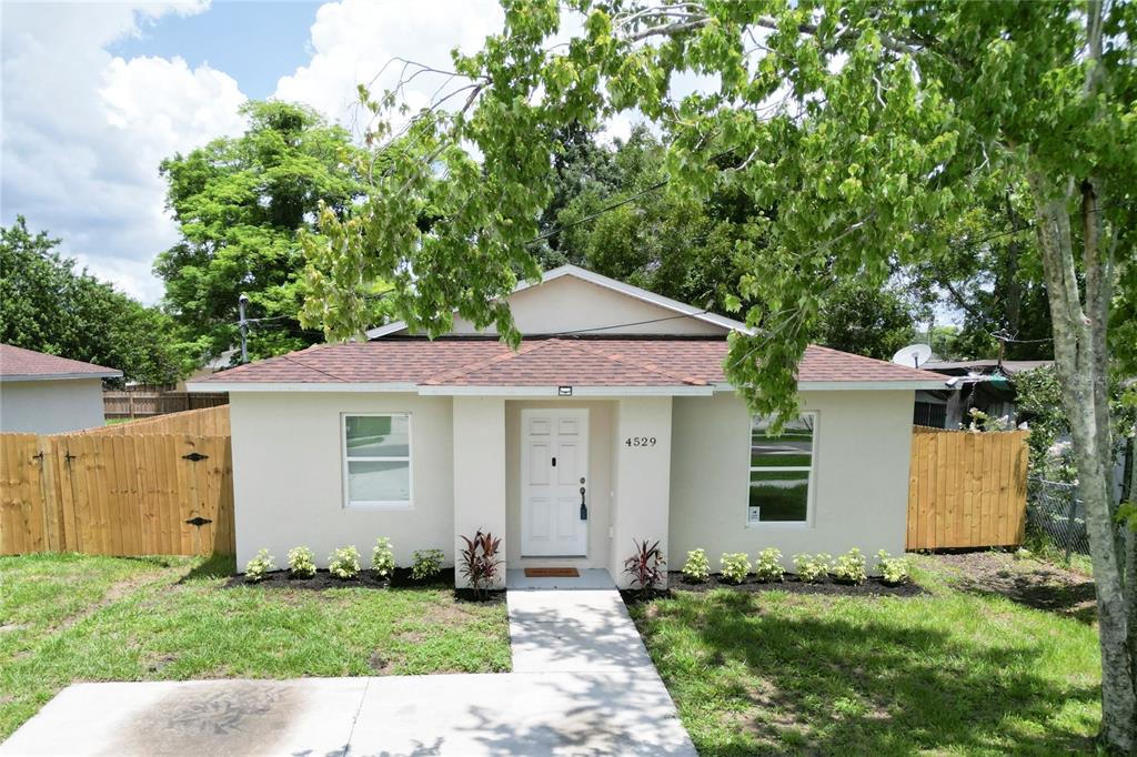 a front view of a house with a garden