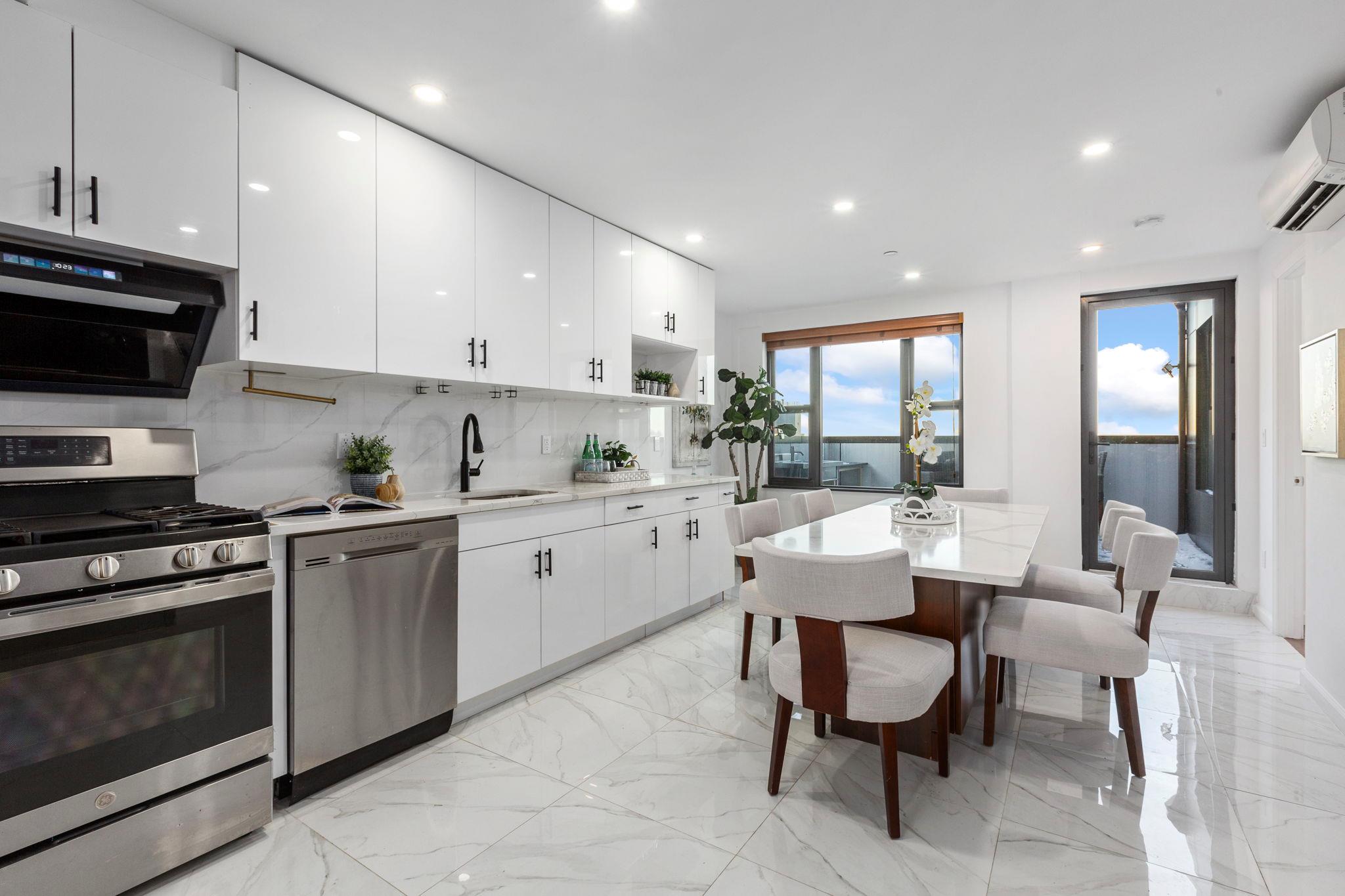 a kitchen with a sink cabinets and stainless steel appliances