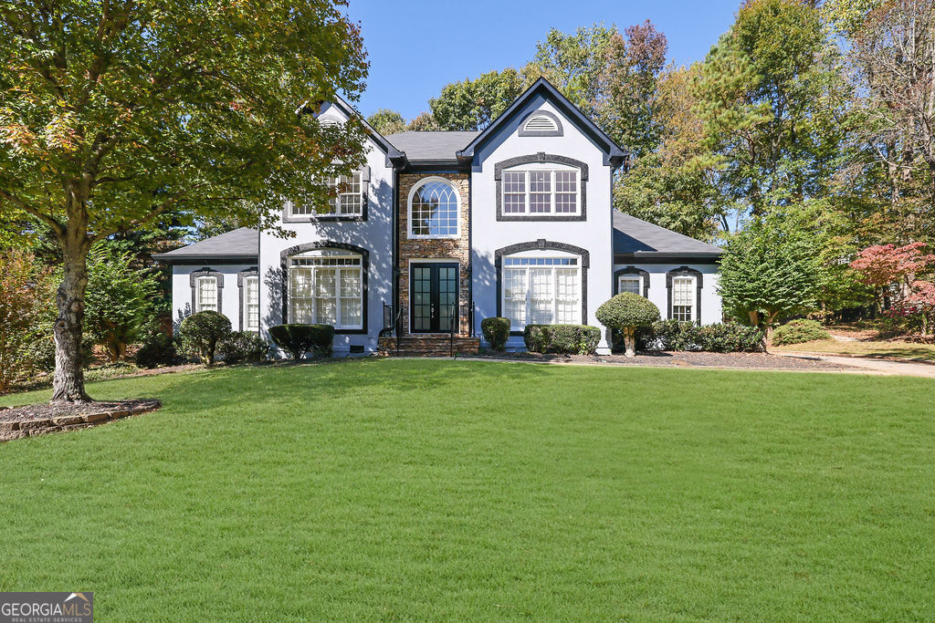 a front view of a house with a garden