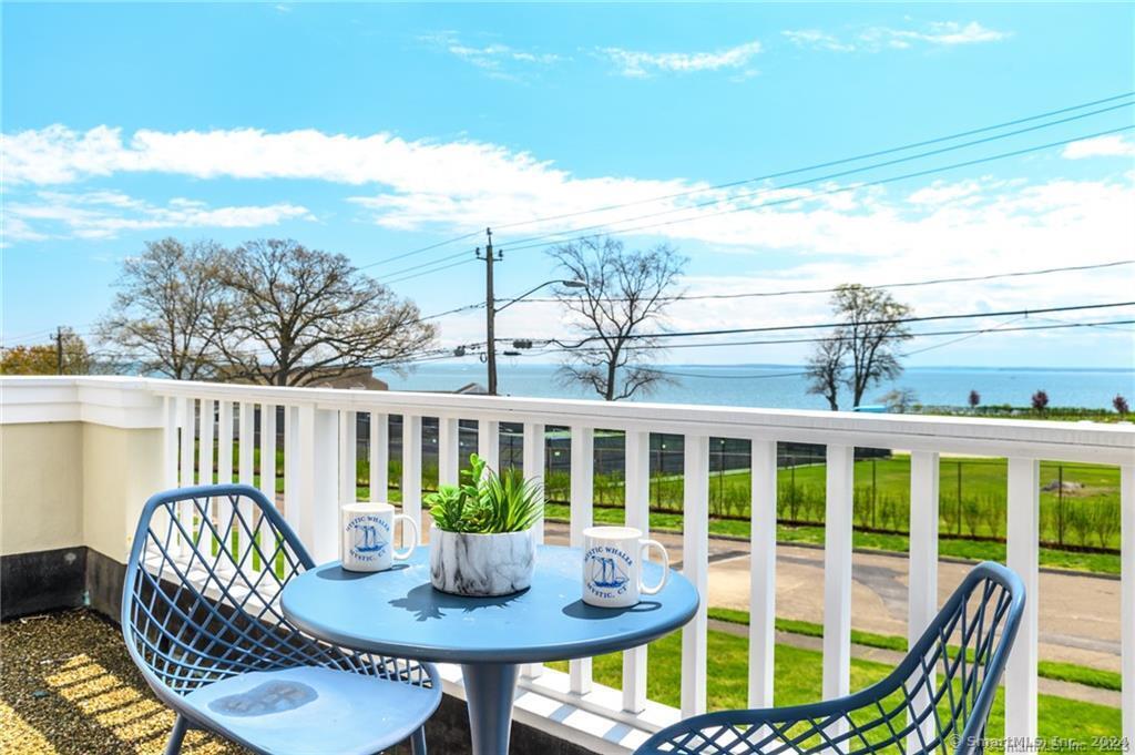 a view of a balcony with table and chairs