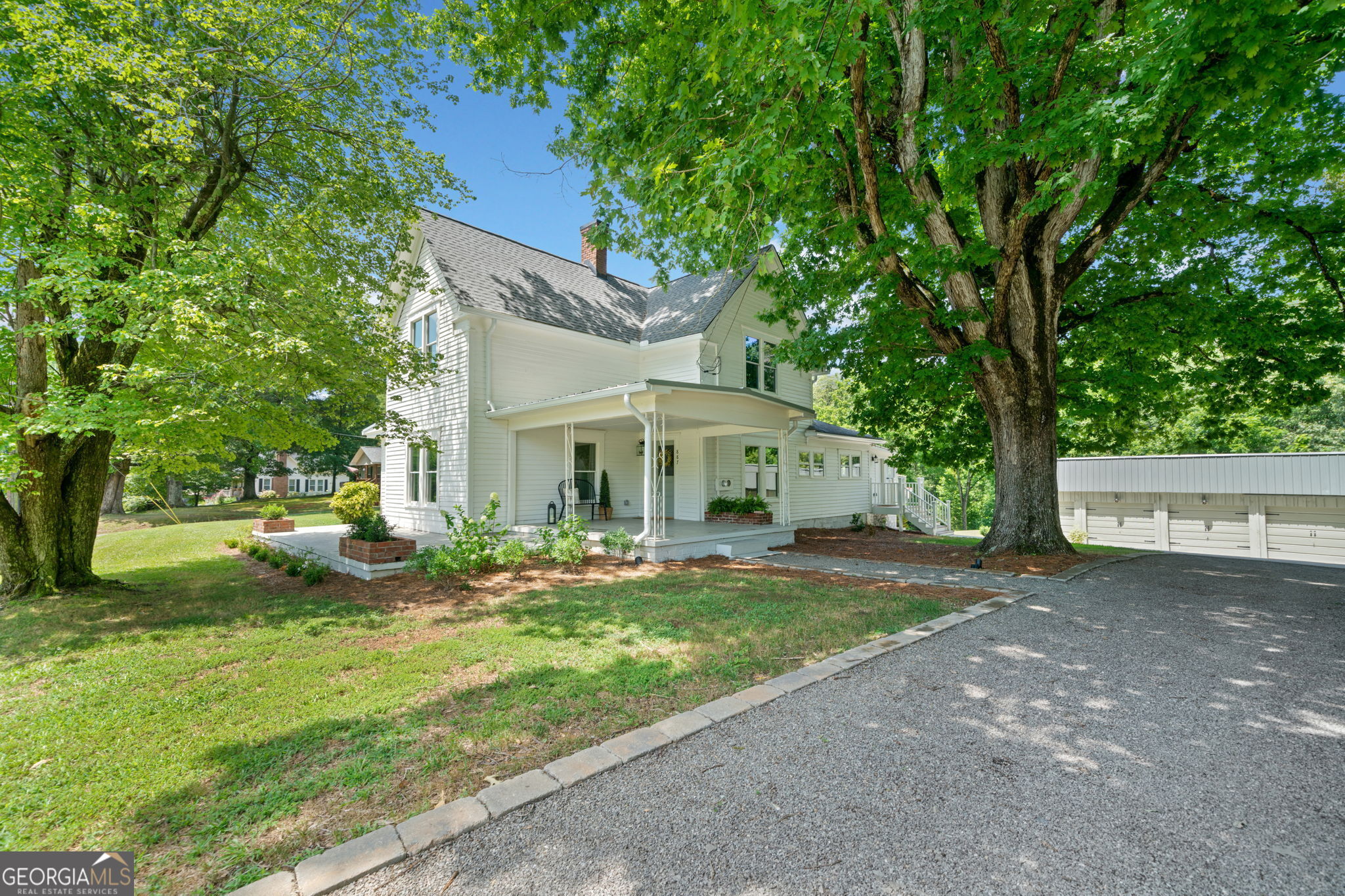 a view of a house with backyard and sitting area