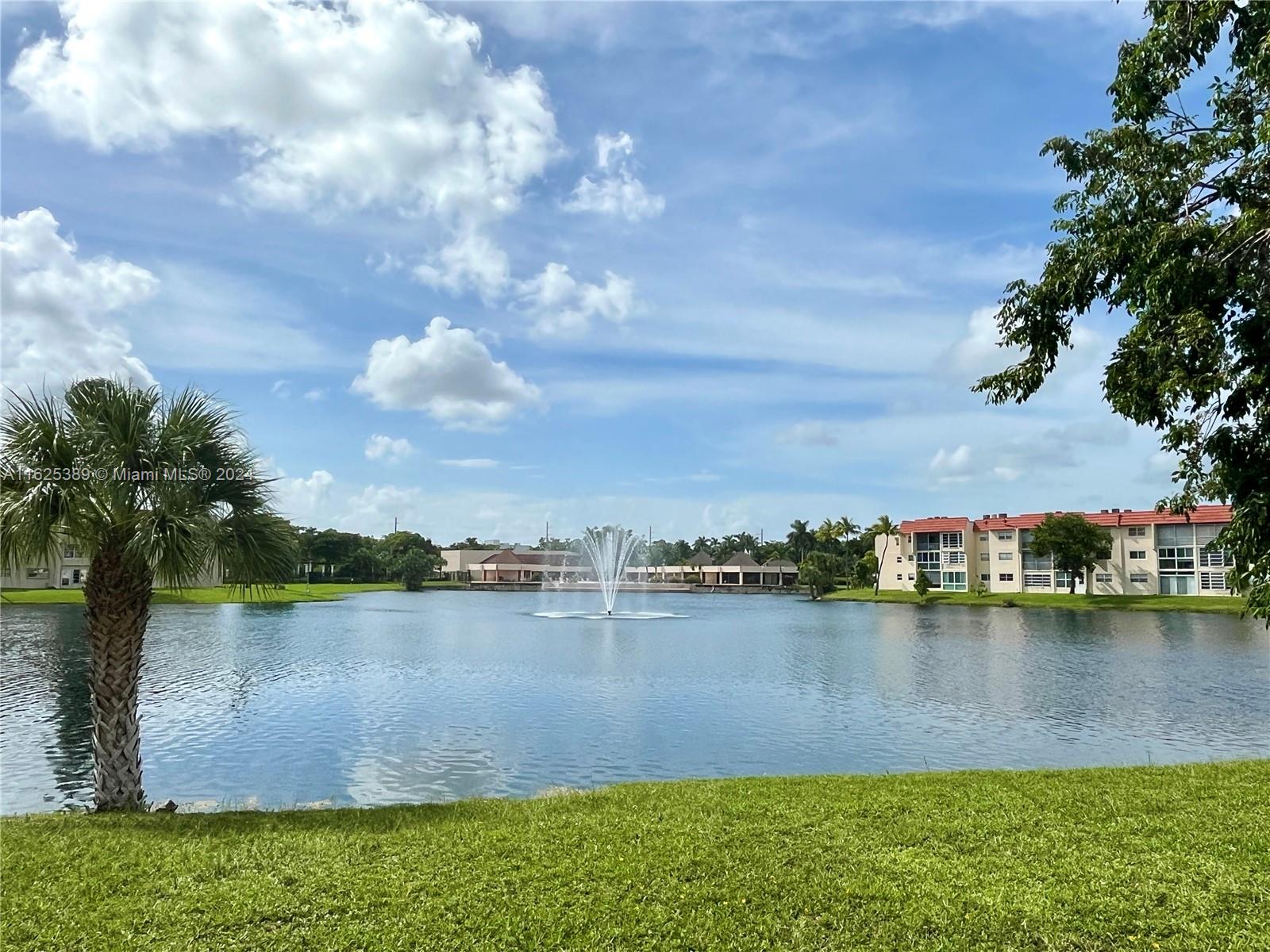 a view of a lake with houses in the back