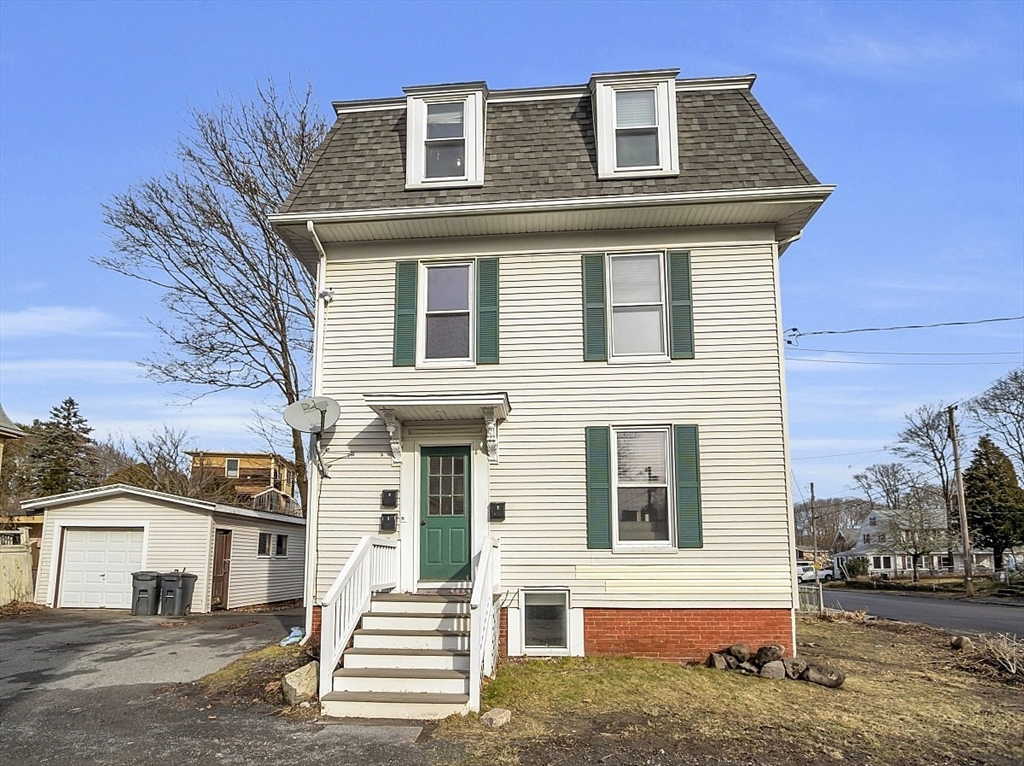 a front view of a house with a yard