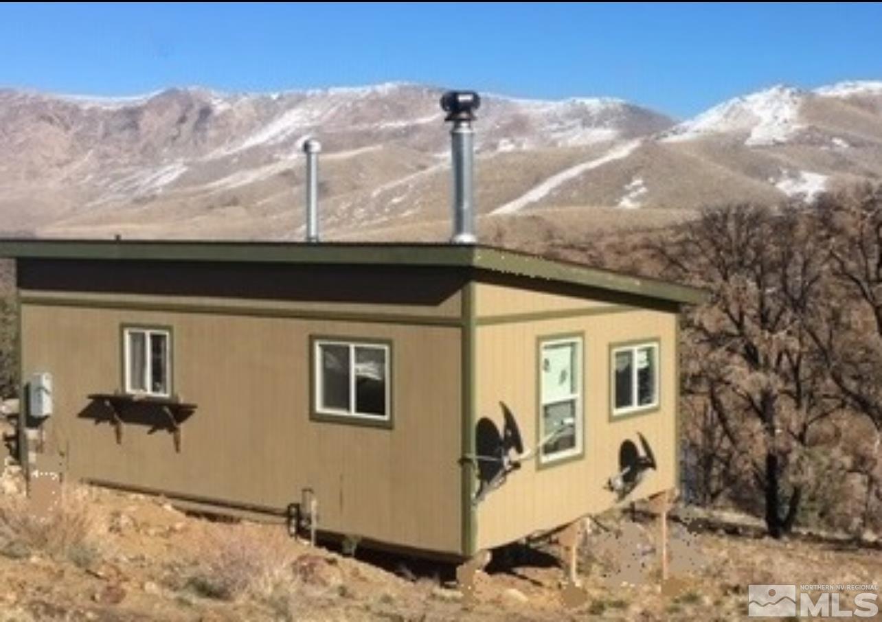 a view of a house with a backyard