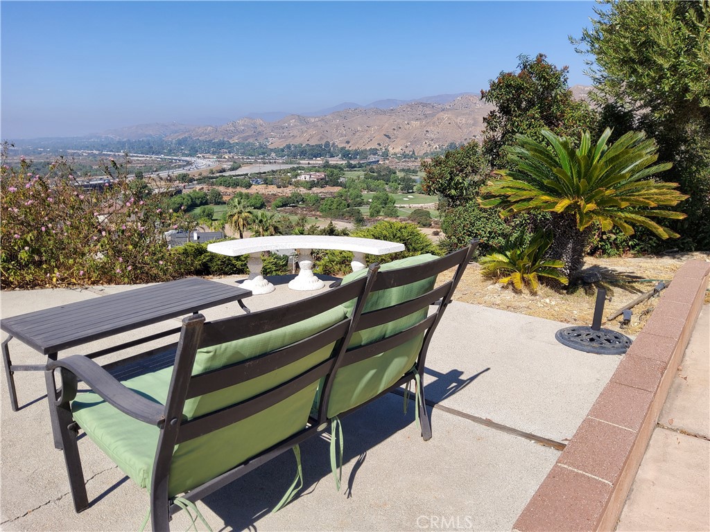 a view of a chairs and table in patio