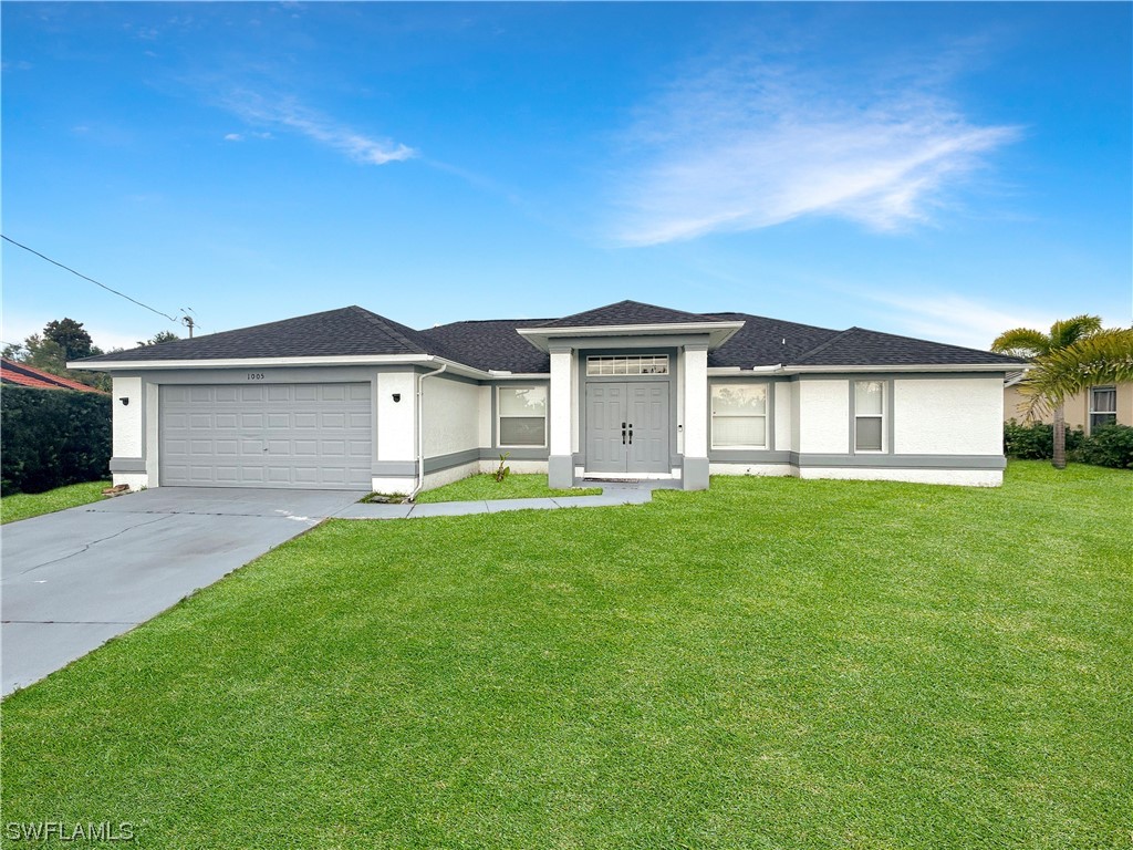 a front view of a house with a garden