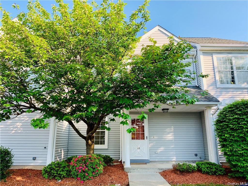 a house that has a tree in front of the house