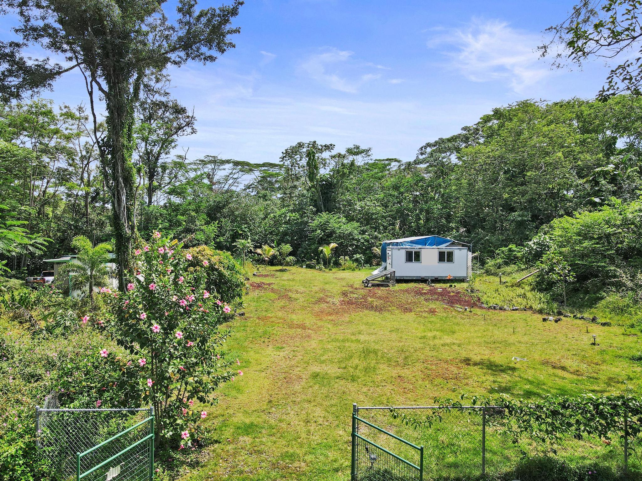 a small yard with trees in the background