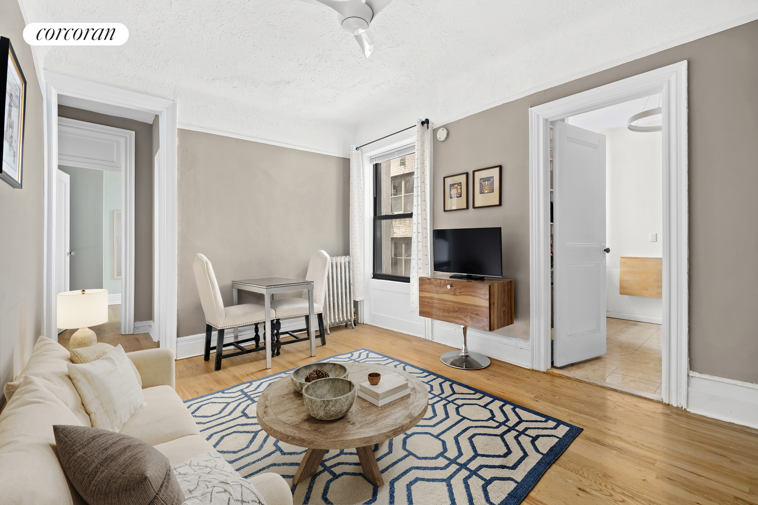 a living room with furniture and a wooden floor