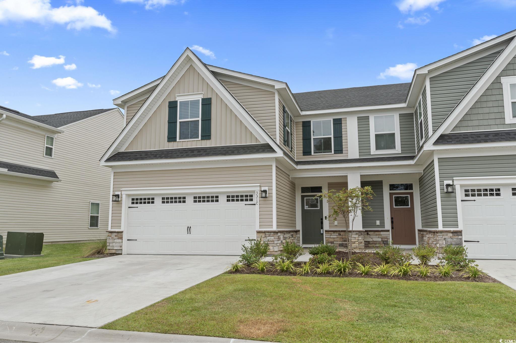 Craftsman-style end unit townhouse featuring a 2 c