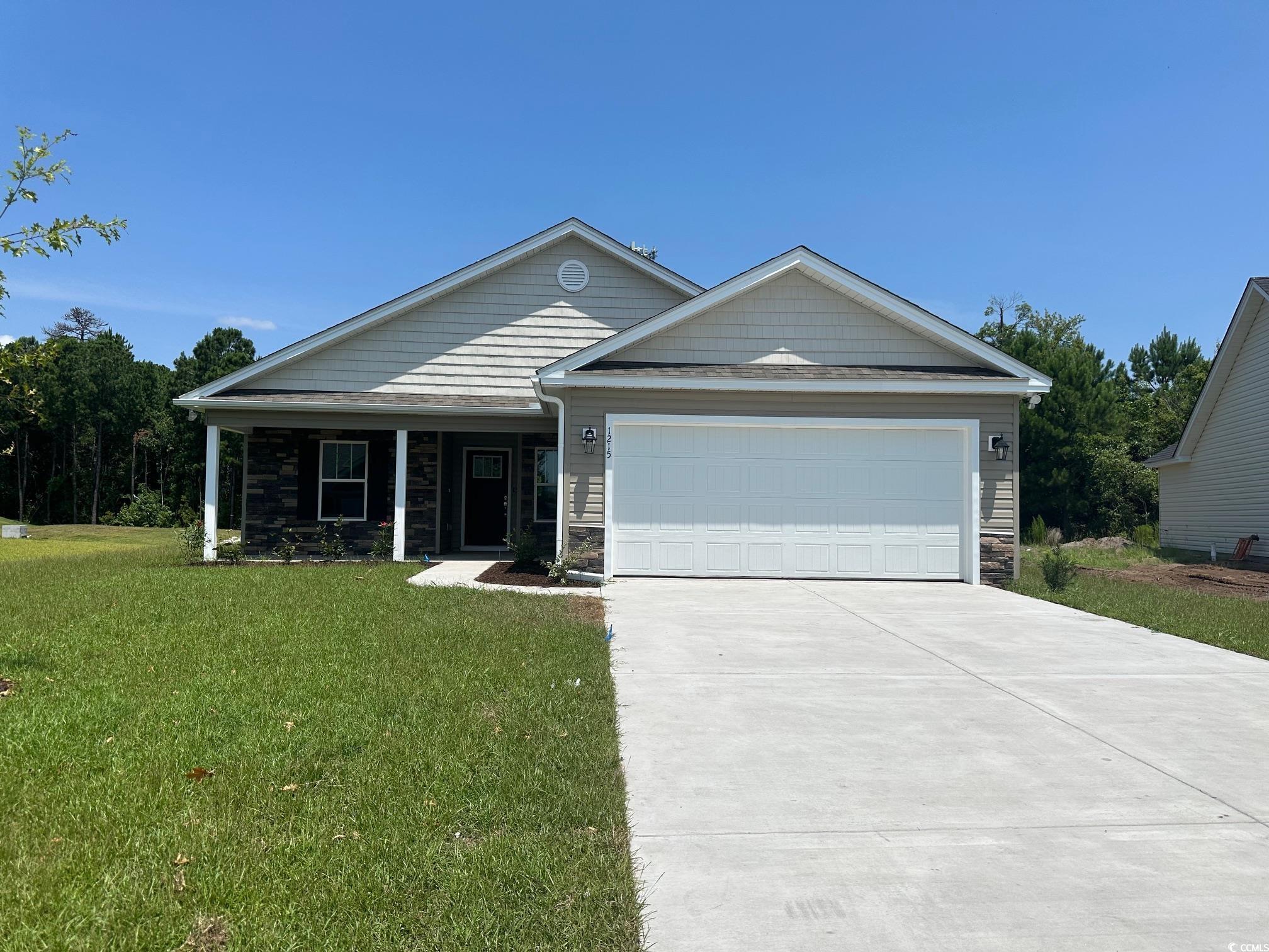 View of front of property featuring a garage and a