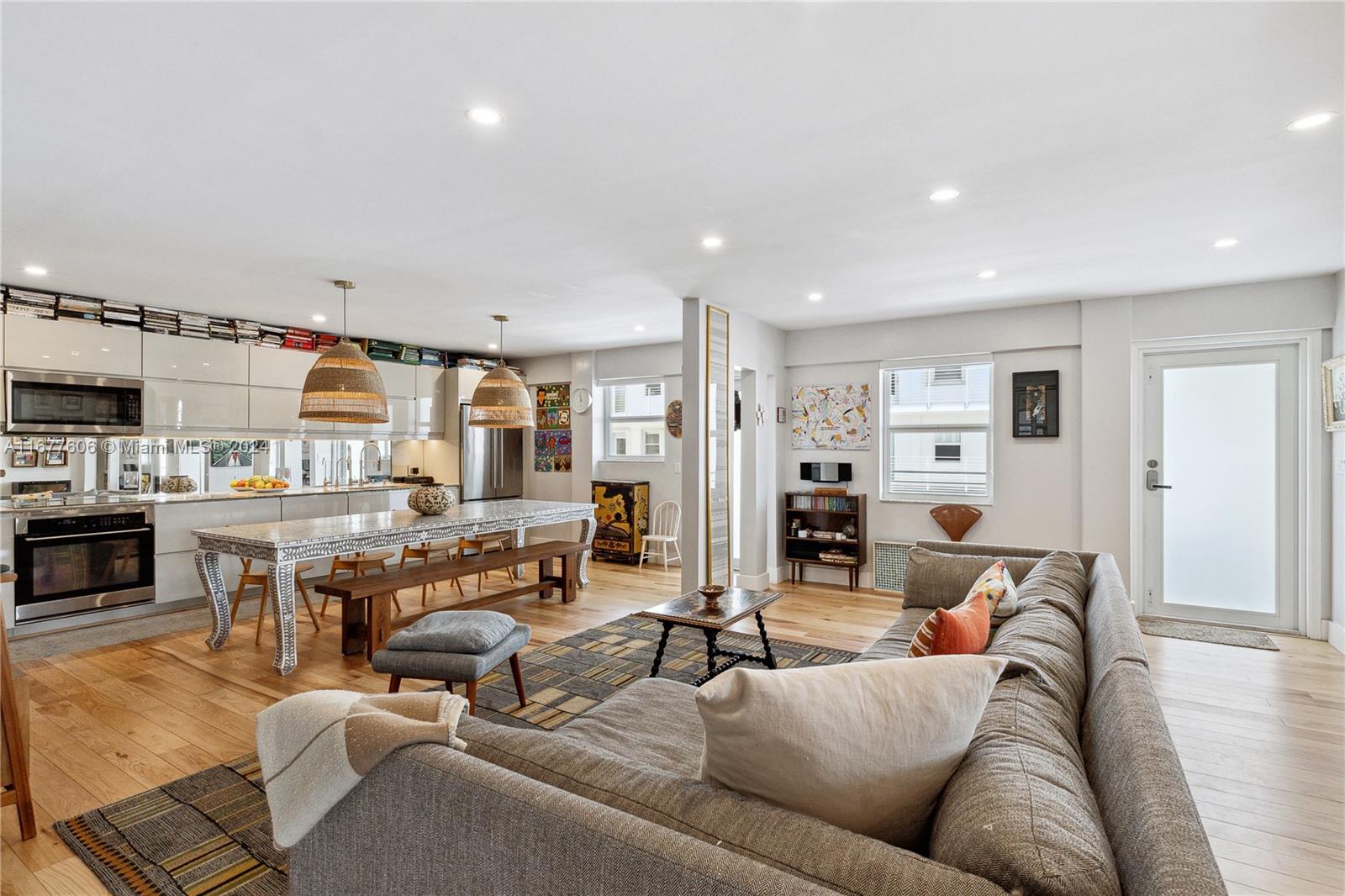 a living room with furniture kitchen view and a window