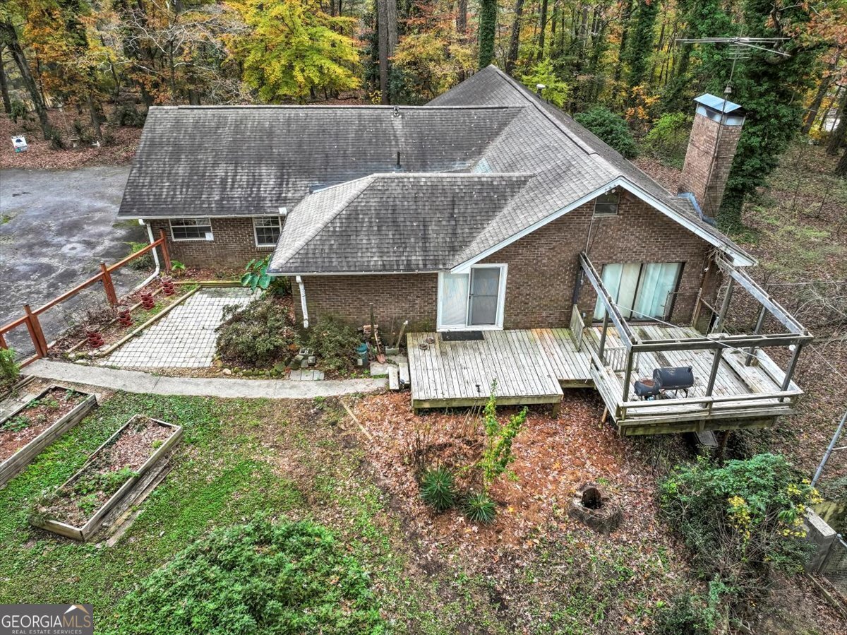 an aerial view of a house with a yard table and chairs