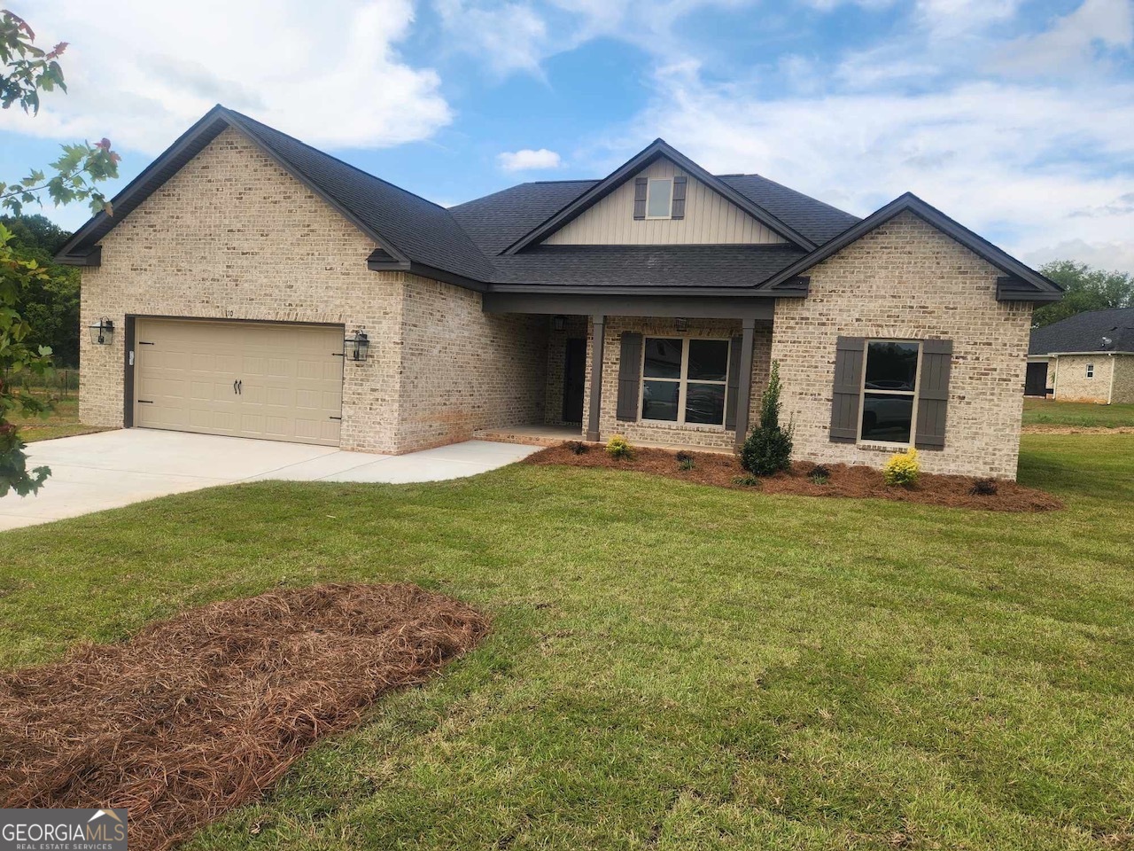 a front view of a house with a yard and garage