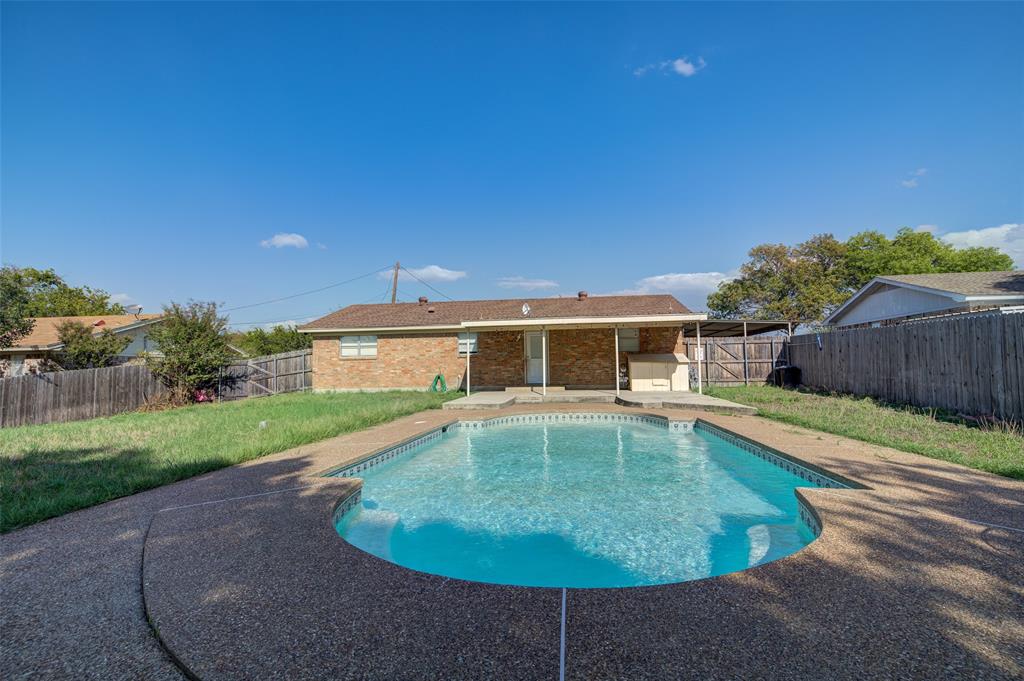 a view of a house with swimming pool yard and outdoor seating