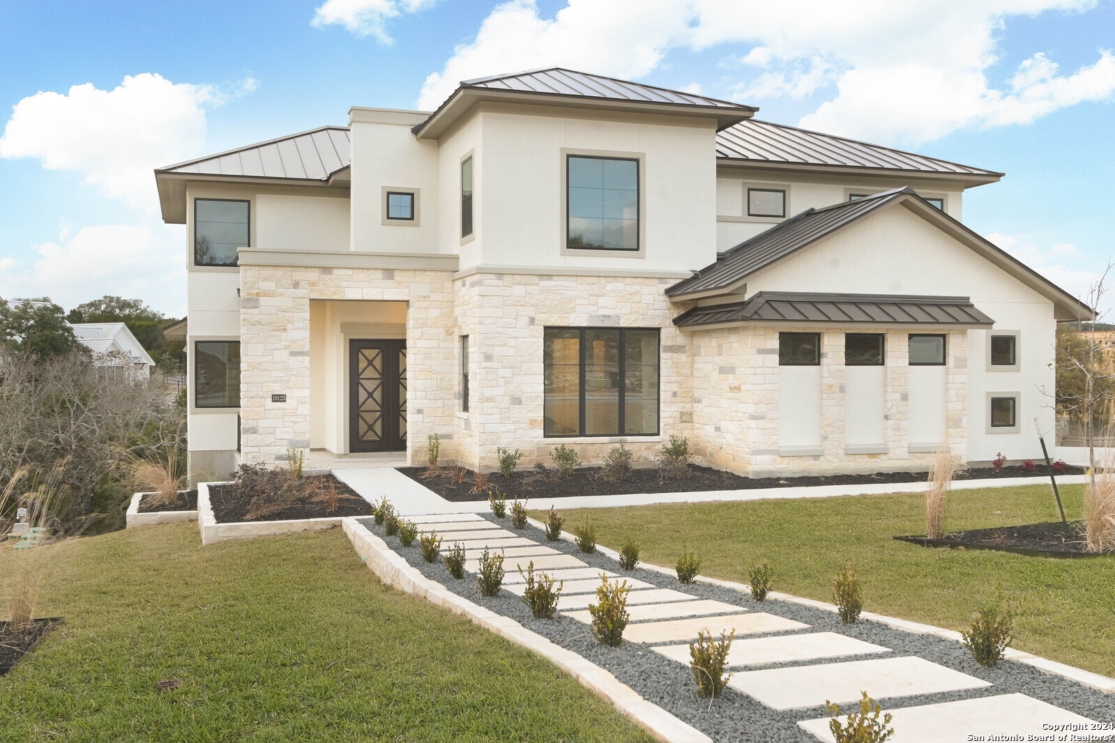 a view of a house with swimming pool and a yard