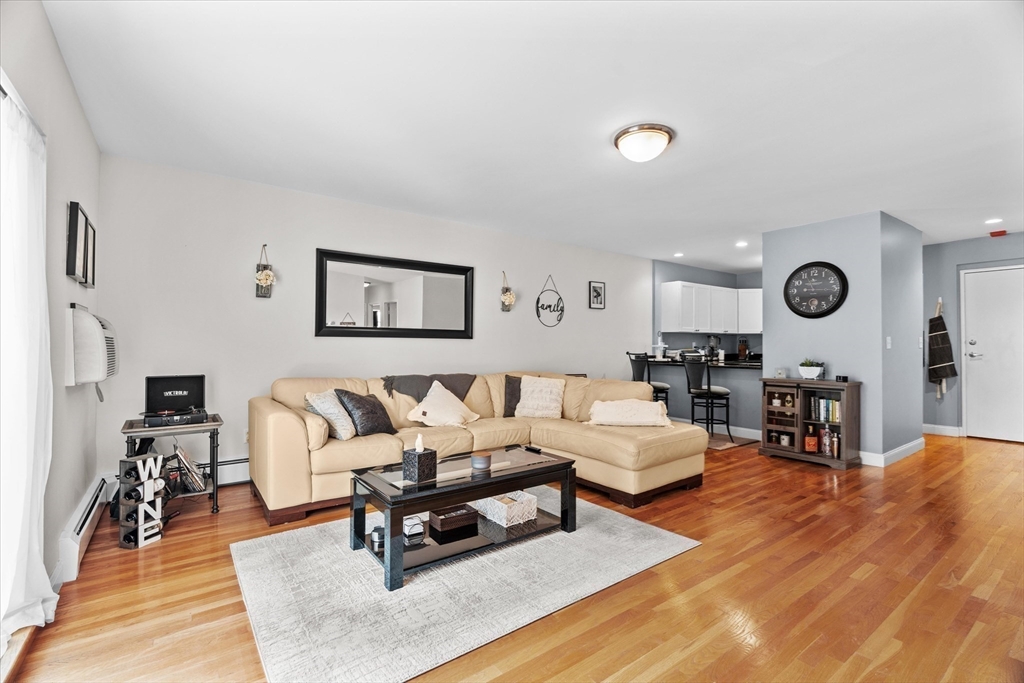 a living room with furniture and view of kitchen