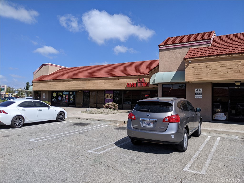 a view of building with cars parked