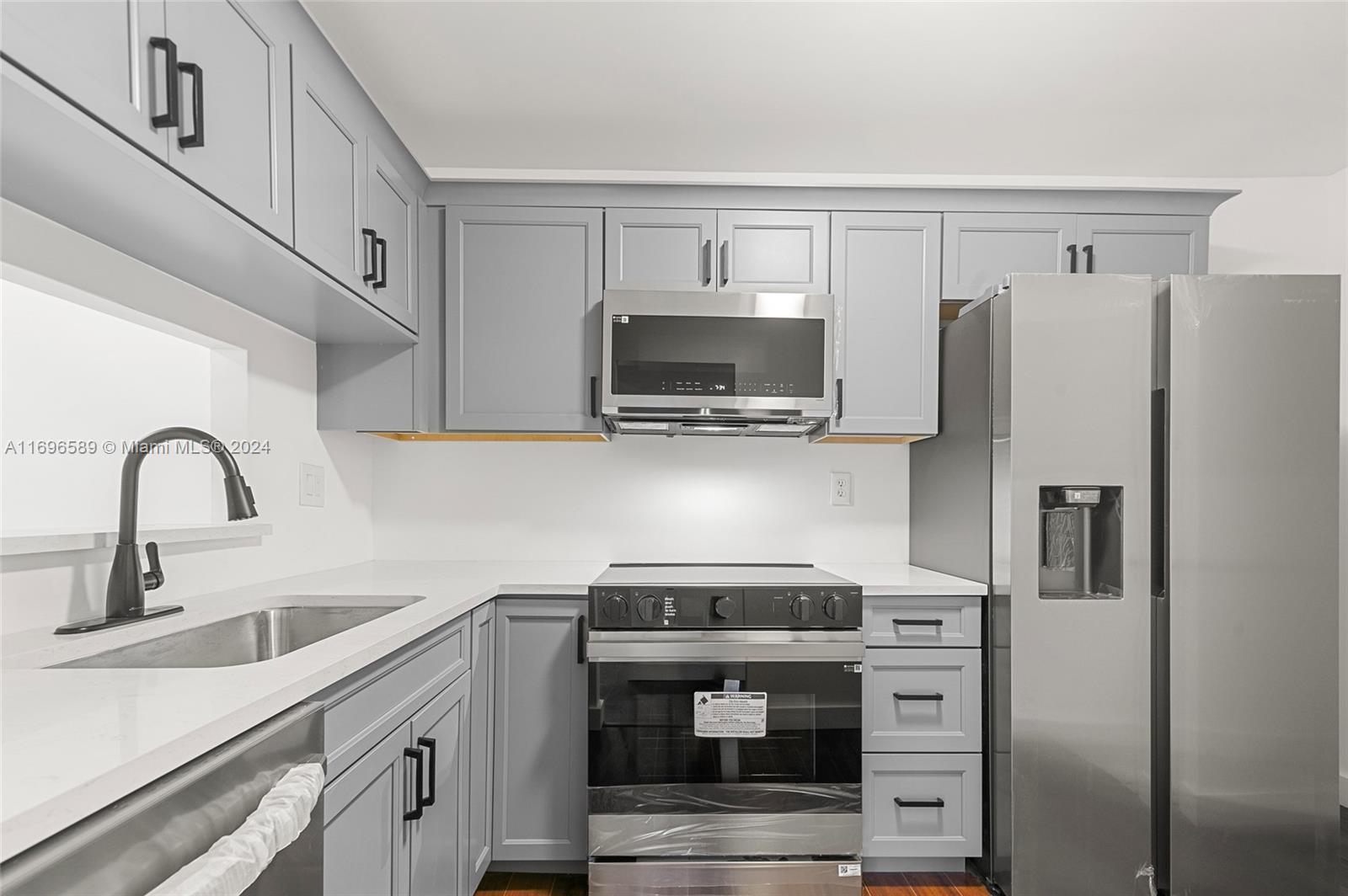 a kitchen with stainless steel appliances a refrigerator stove and sink