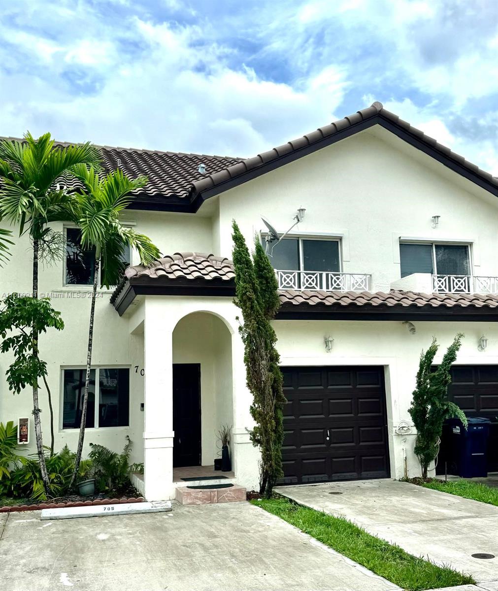 a front view of a house with a garden