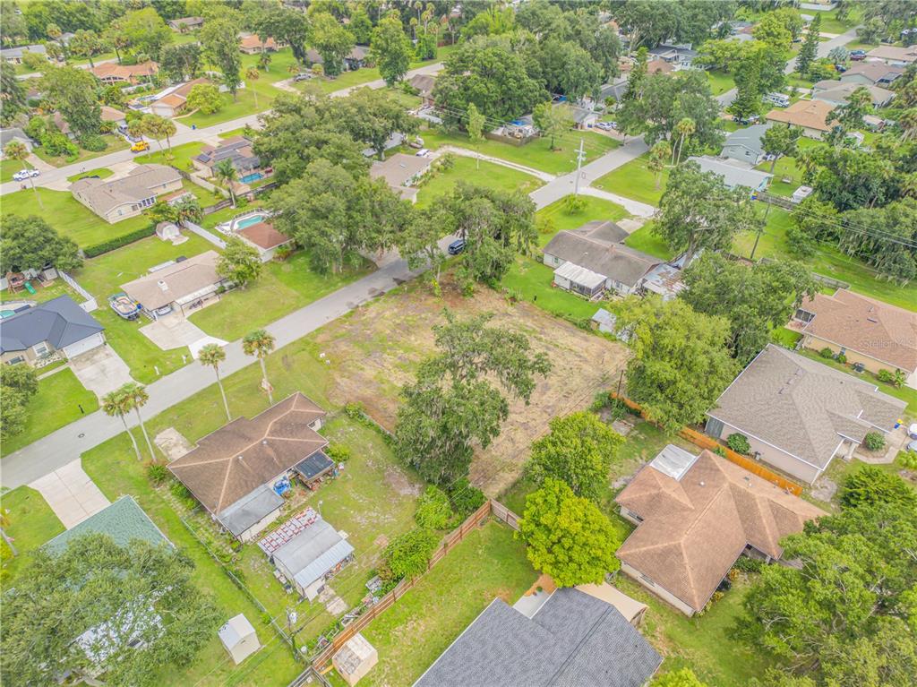 an aerial view of residential houses with yard