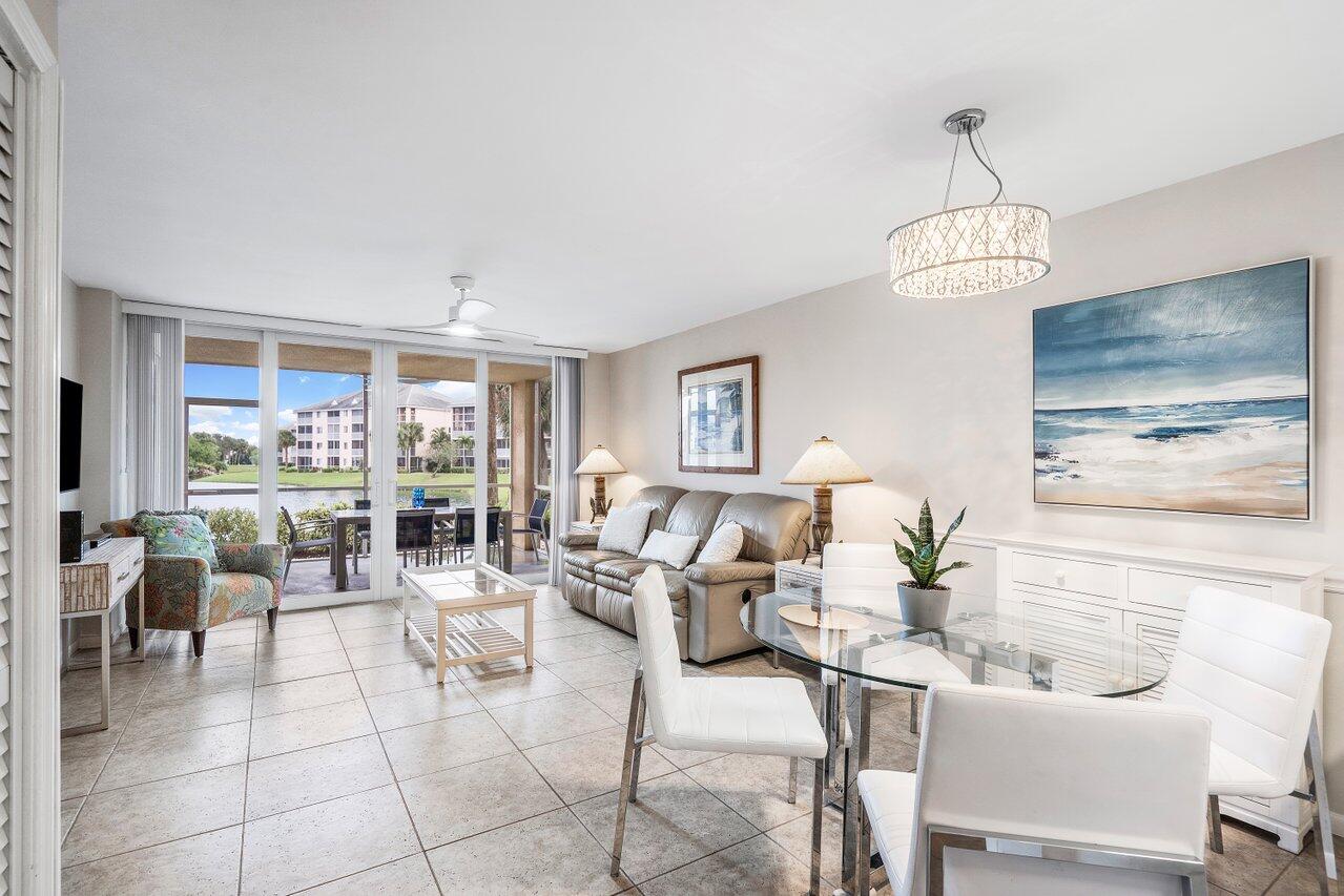 a living room with couches a dining table and chairs with wooden floor