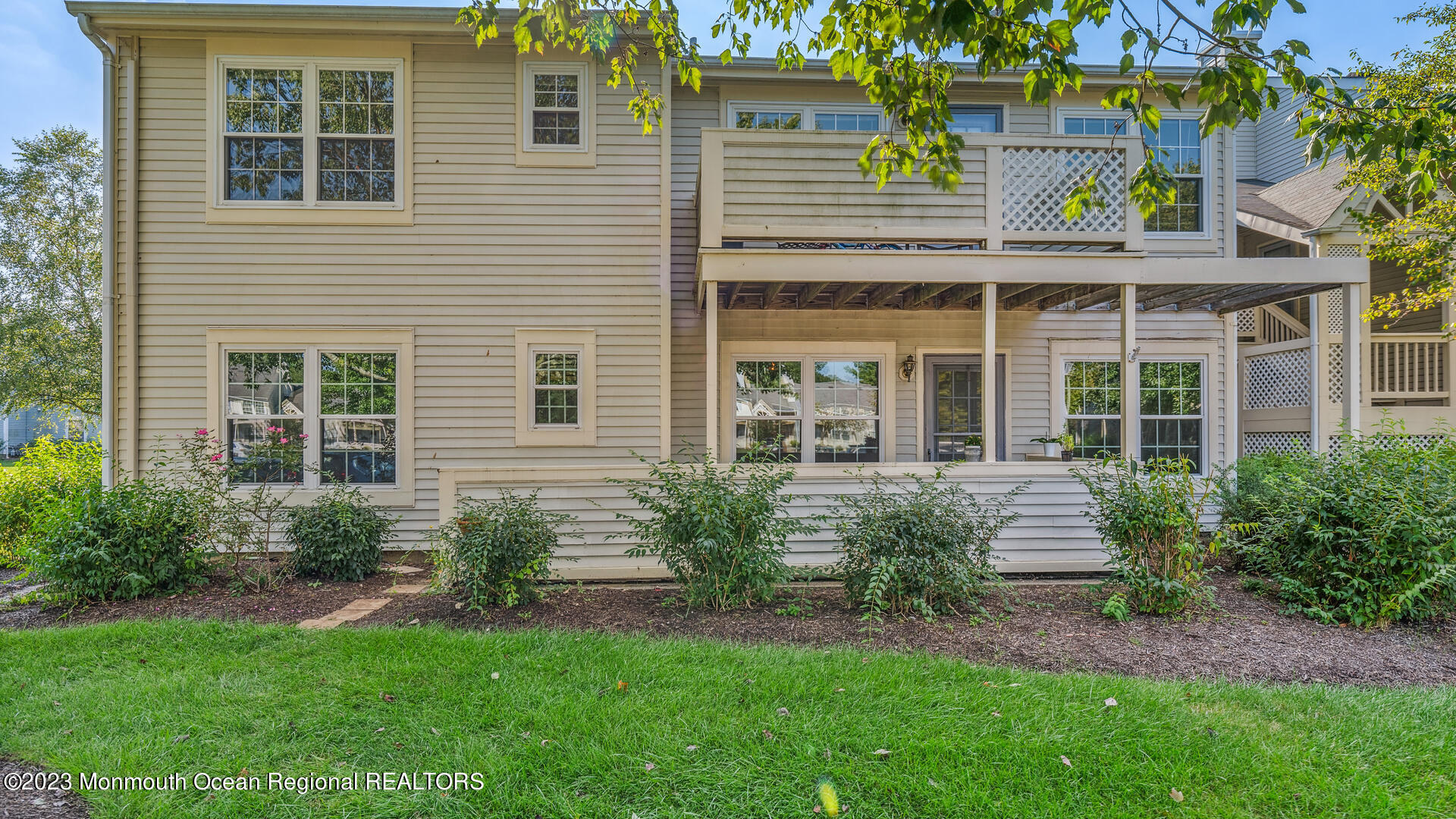 a front view of a house with garden and porch