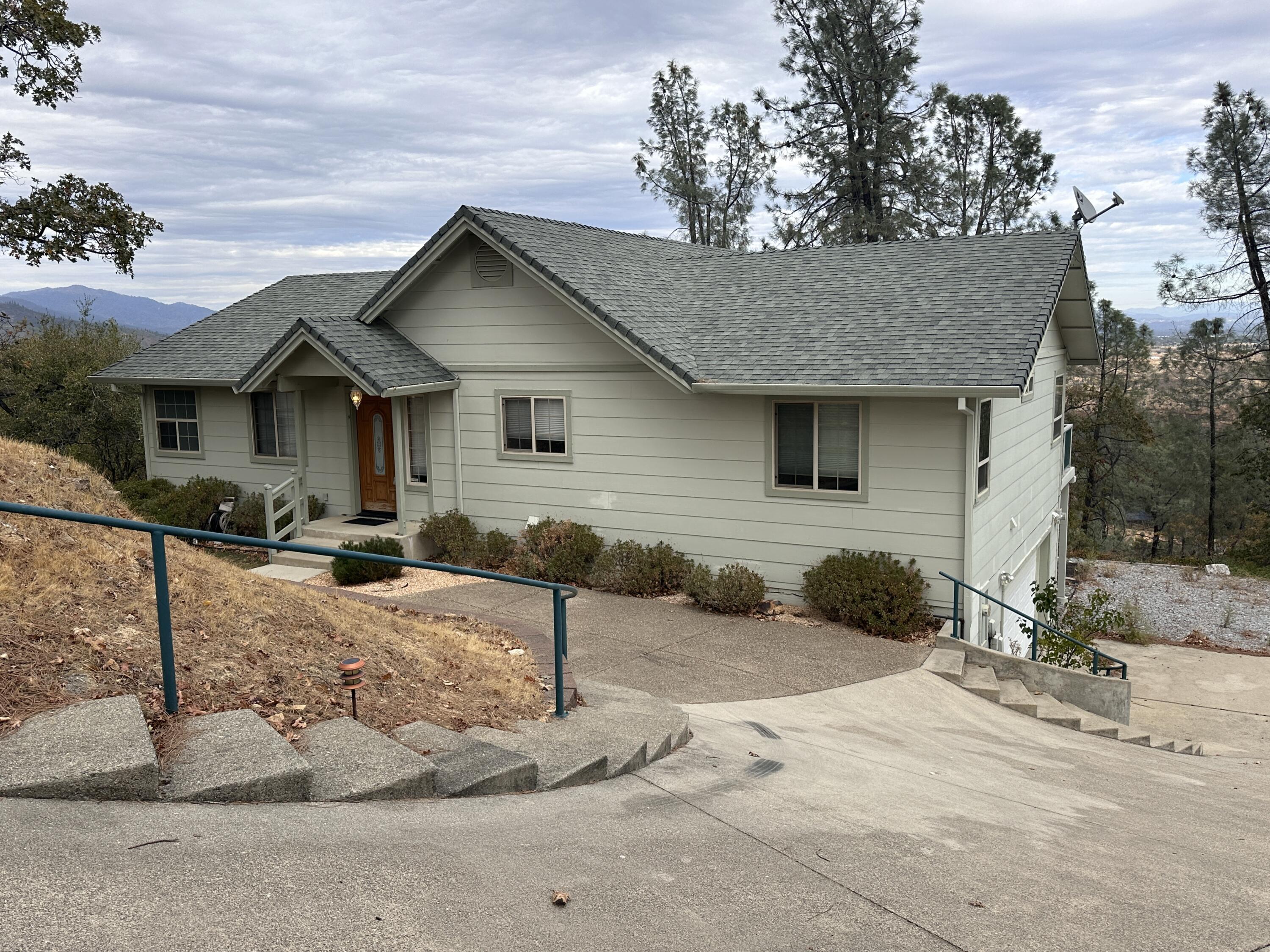 a front view of a house with a yard covered in snow