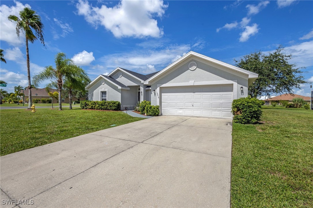 a front view of a house with a yard and garage