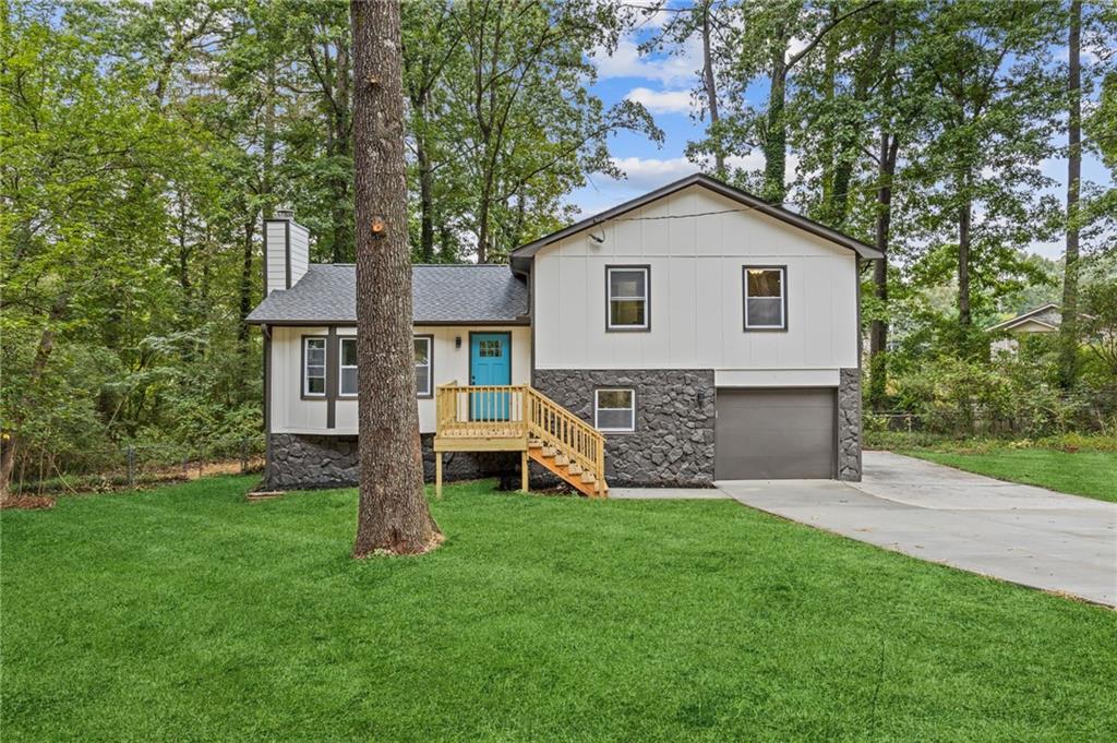 a view of a house with a yard and sitting area