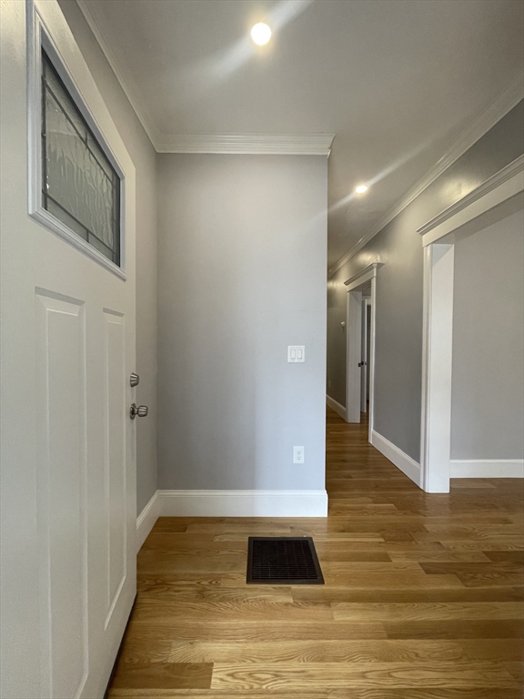 a view of a hallway with wooden floor