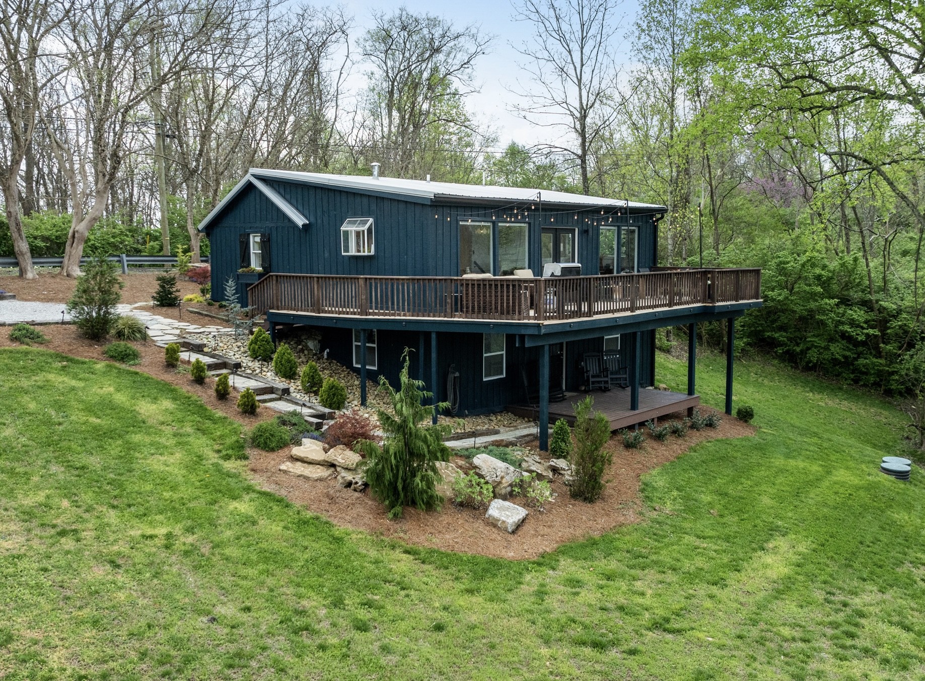 a view of house with backyard and sitting area