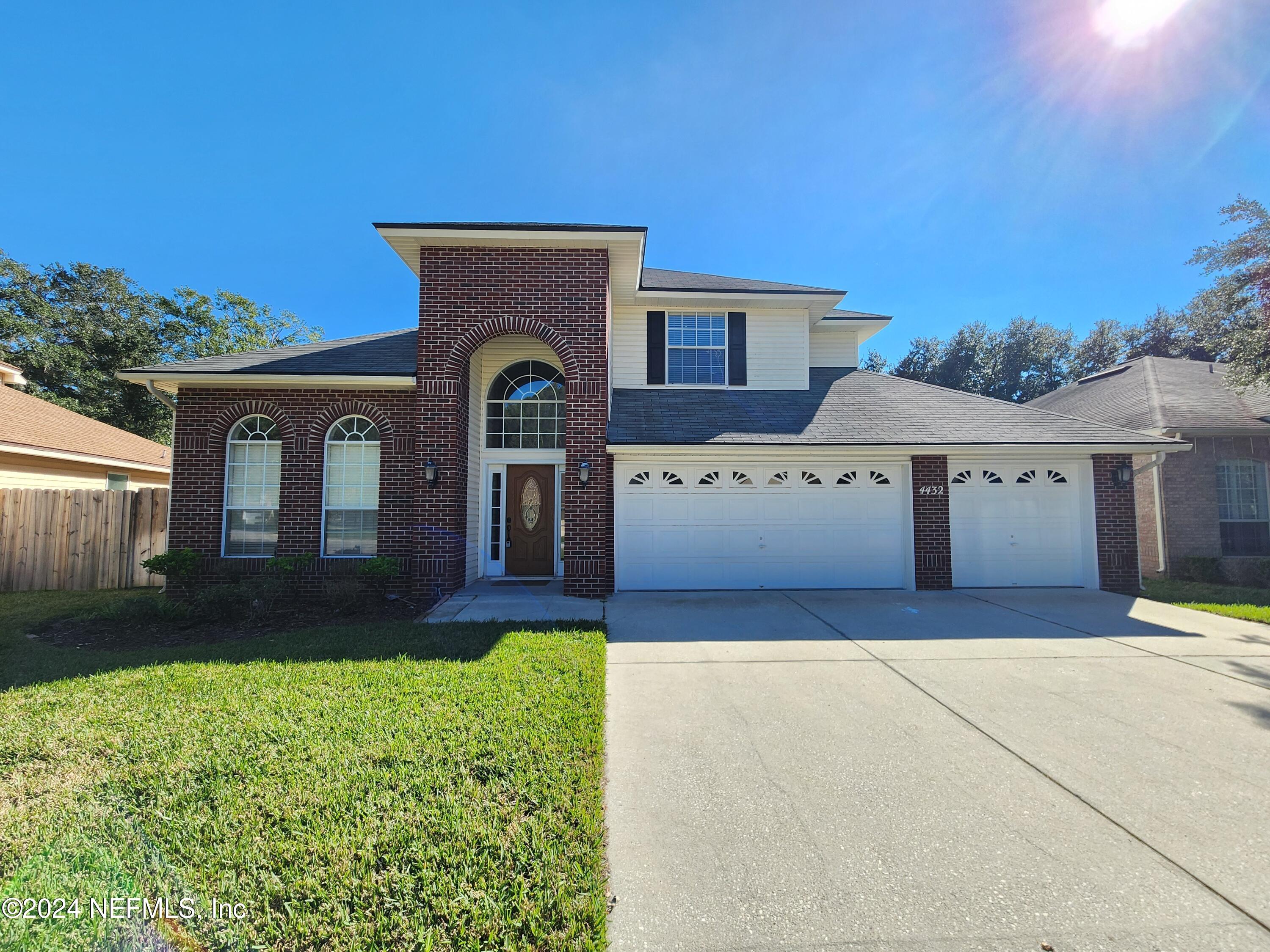 a front view of a house with a yard and garage